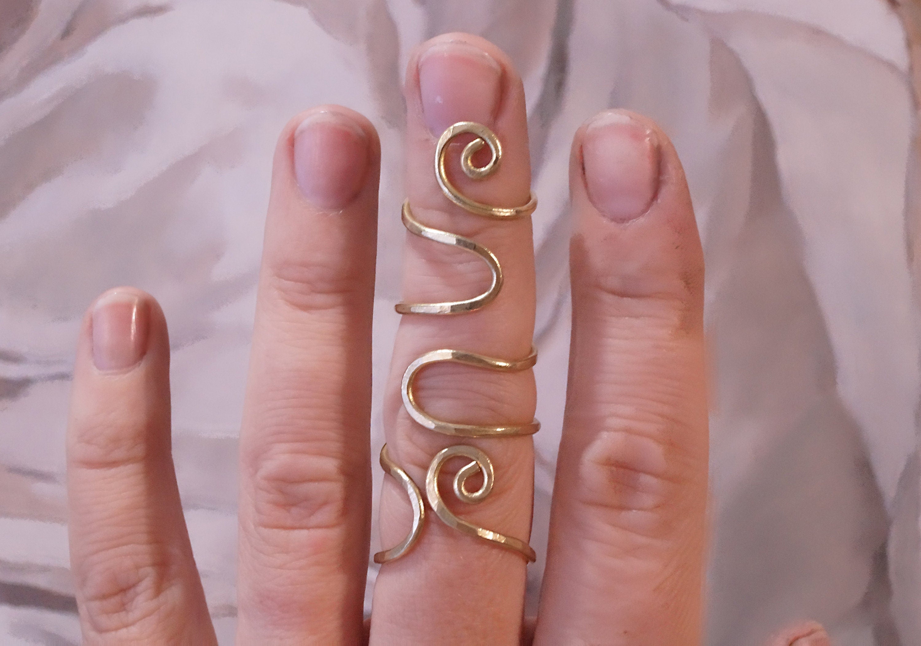 Adjustable brass finger splint ring designed to support both finger joints and improve alignment