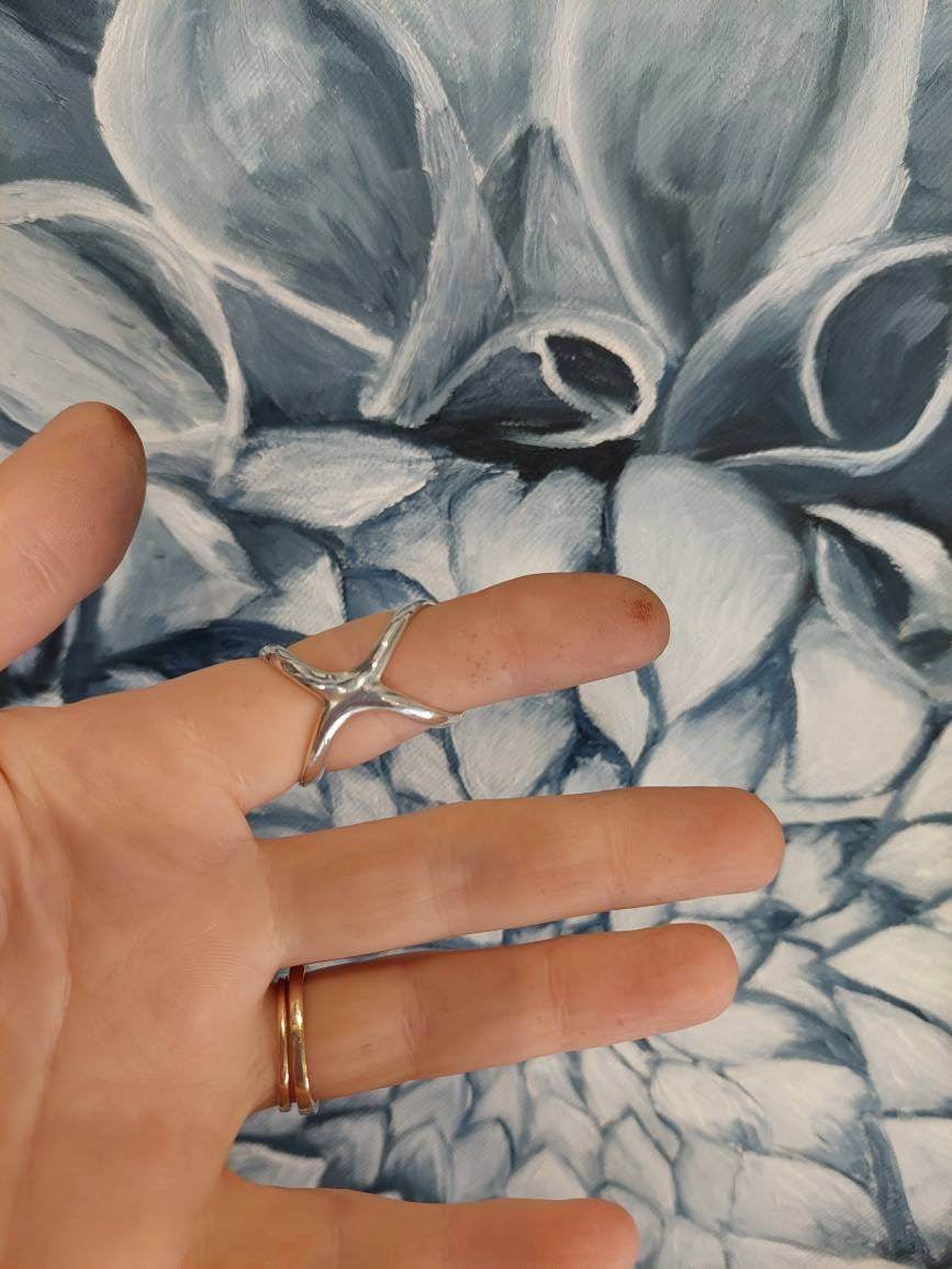 Close-up of a butterfly finger splint ring with handcrafted details and comfortable design
