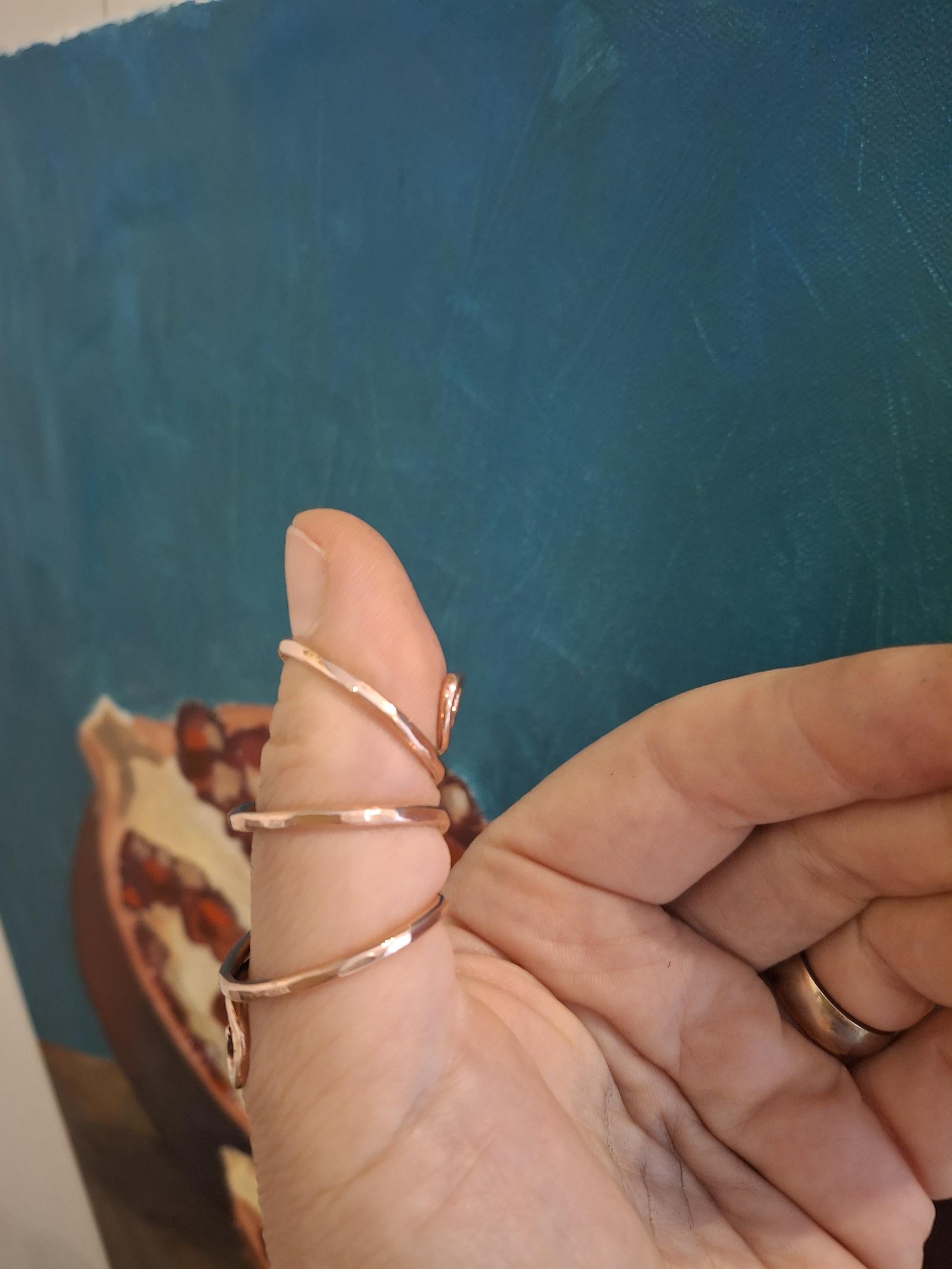 Side view of a copper thumb  splint ring showing ergonomic support for thumb
