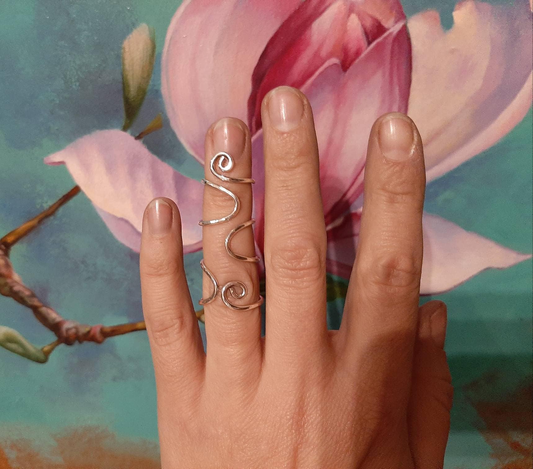 Side view of an adjustable sterling silver finger splint ring supporting both finger joints