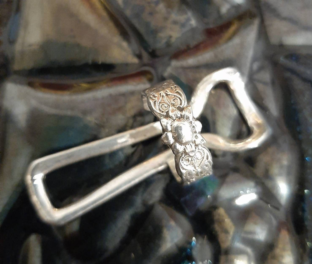 Close-up of an adjustable finger splint ring with polished handcrafted finish
