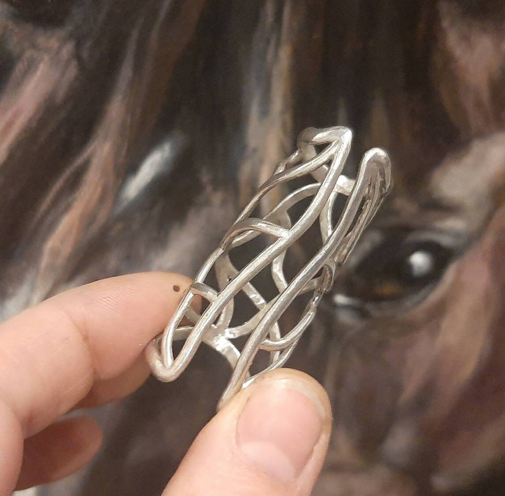 Close-up of a sterling silver full finger splint ring with support for both joints