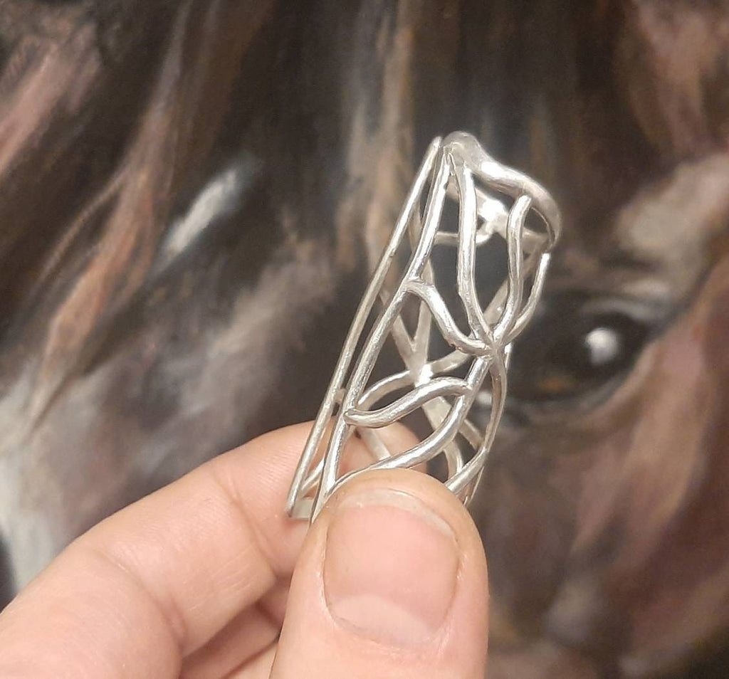 Side view of a sterling silver full finger splint ring supporting  joints