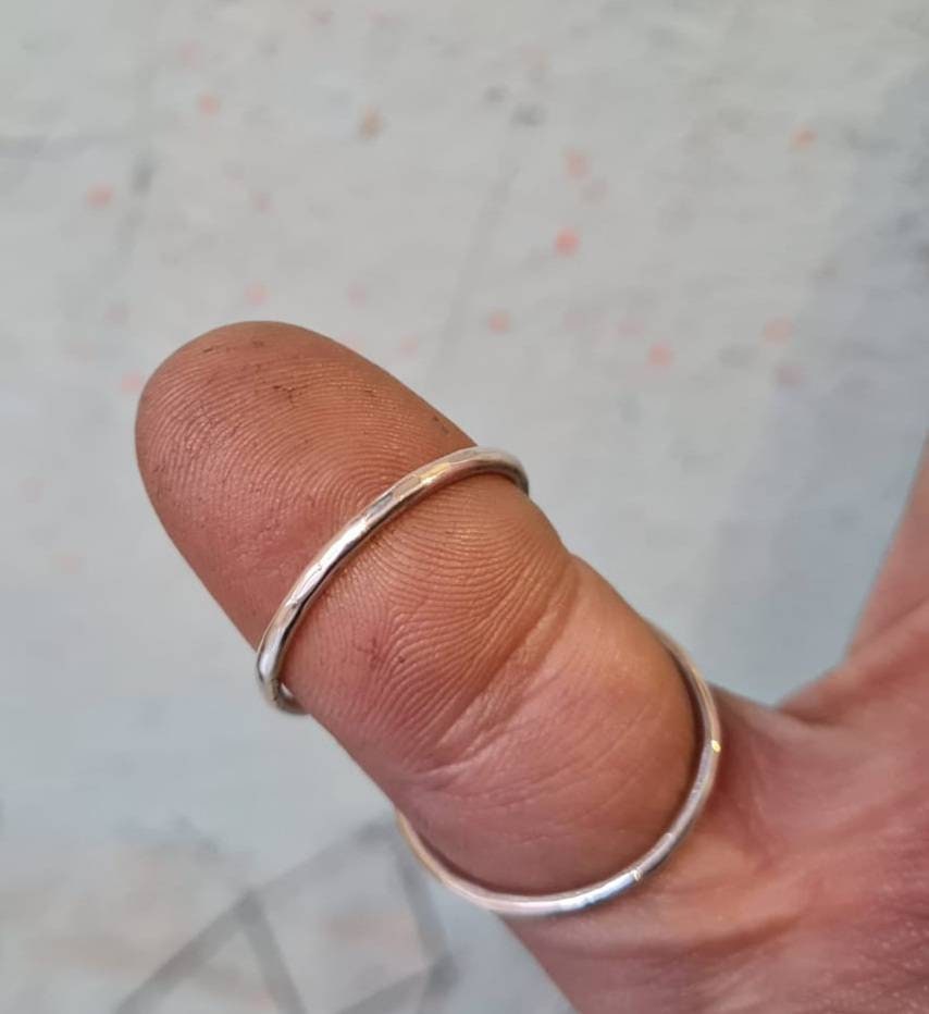 Side view of a handmade hammered thumb splint ring crafted in sterling silver, brass, or copper