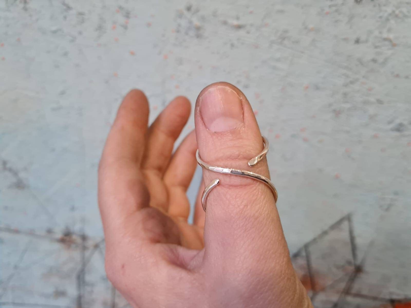 Close-up of a hammered textured thumb splint ring with handcrafted finish