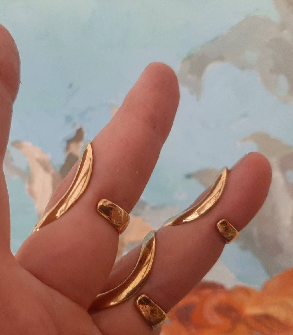 Side view of a handmade adjustable silver finger support ring with minimalist design