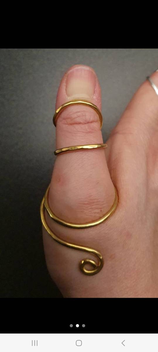 Yellow brass thumb splint ring worn for thumb support and improved joint stability