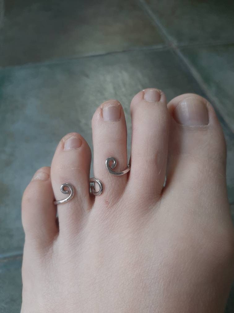 Sterling silver toe splint worn on the foot to help maintain toe alignment and stability