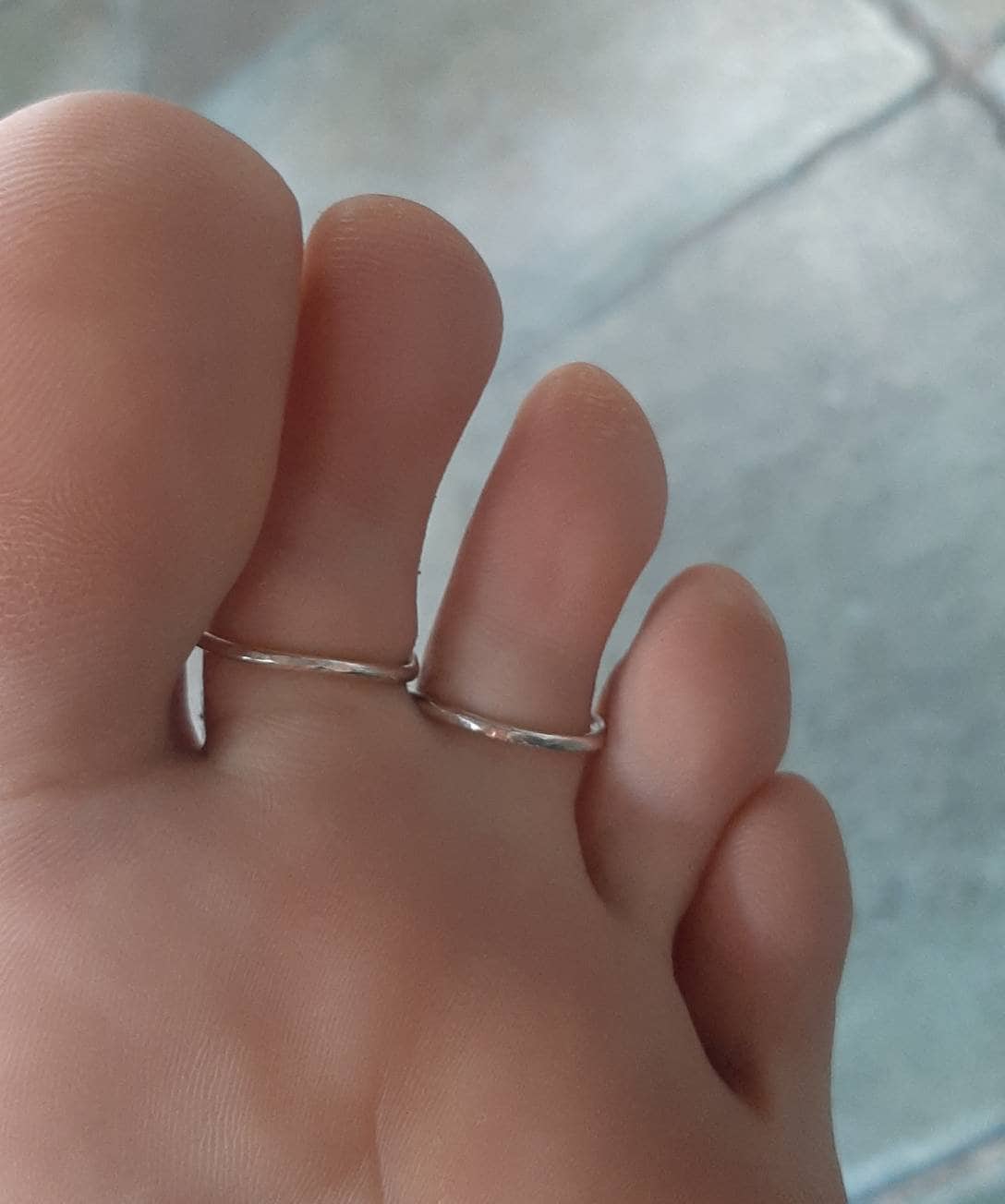 Back view of an adjustable sterling silver toe splint featuring a two ring support design