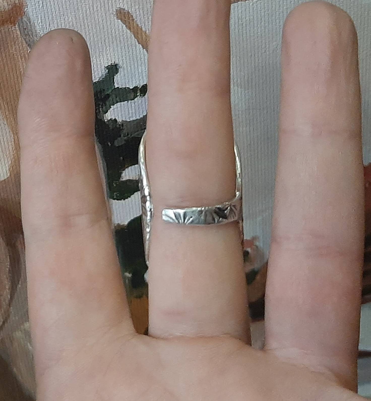 Finger splint ring helping support fingers affected by ulnar deviation and joint instability